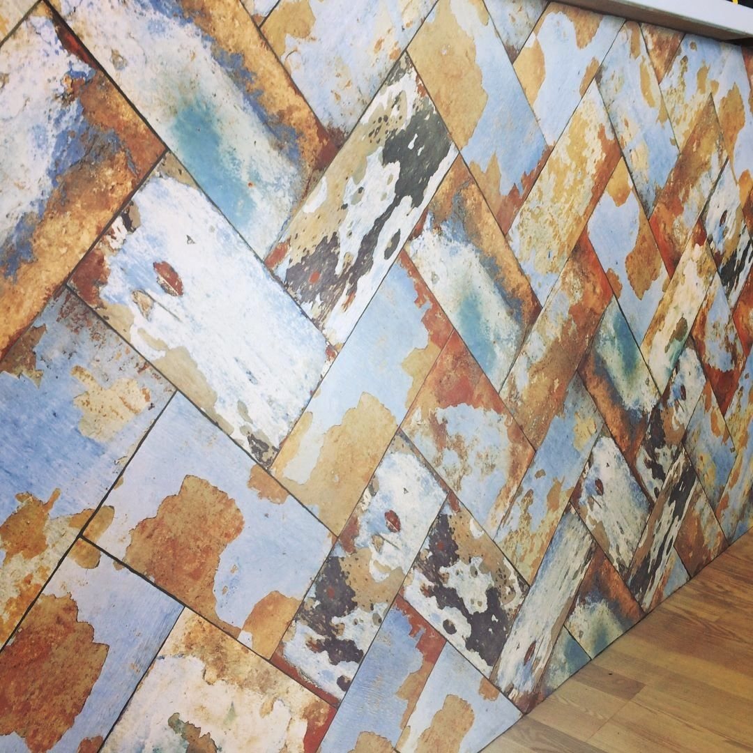 Bar front clad in reclaimed-look herringbone tile