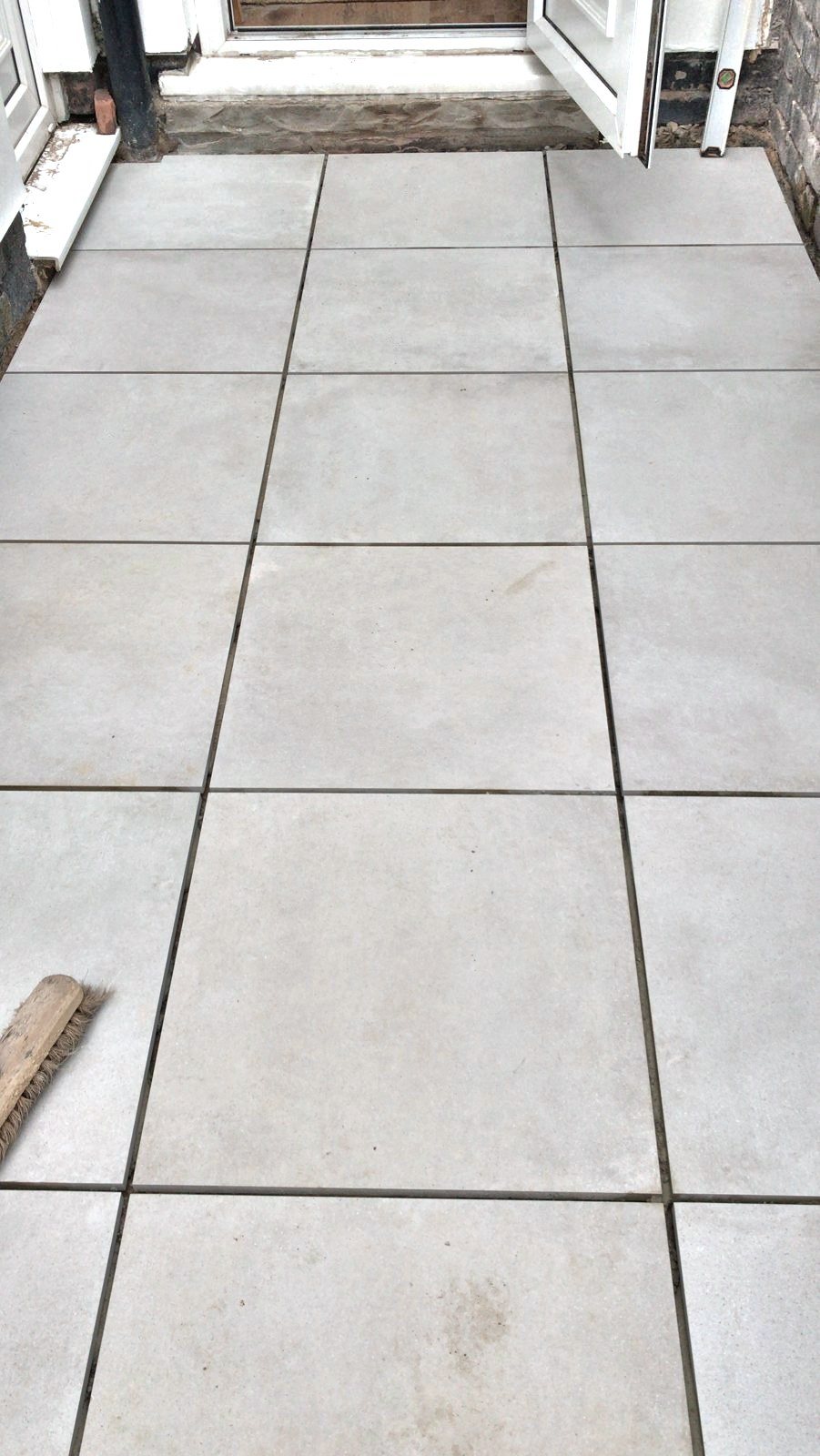 Large-format outdoor porcelain paving laid to a door threshold