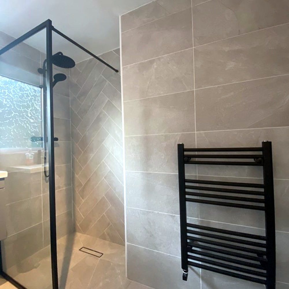 Walk-in shower with a linear drain set flush into the floor